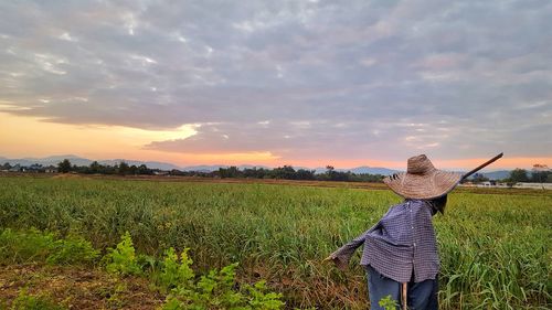 Scarecrow on agricultural field