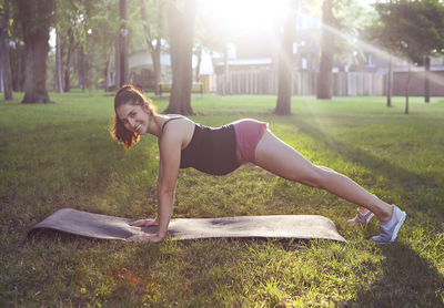 Portrait of smiling woman exercising at park