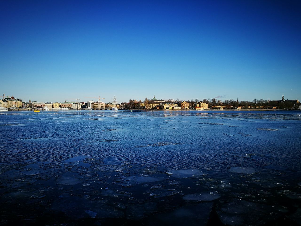 blue, clear sky, water, architecture, built structure, building exterior, city, outdoors, sea, nature, no people, cityscape, day, scenics, beauty in nature, sky