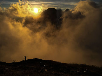 Scenic view of silhouette land against sky during sunset