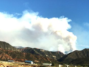 Scenic view of mountains against blue sky