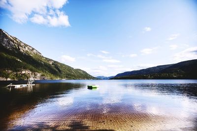 Scenic view of lake against cloudy sky