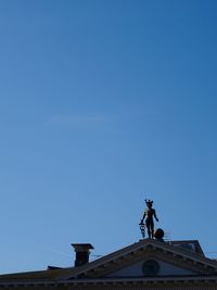 Low angle view of built structure against clear blue sky