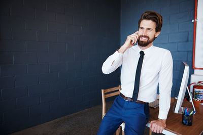 Businessman talking on phone at office