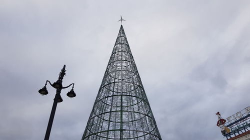 Low angle view of building against cloudy sky