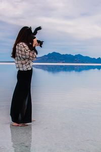 Woman with camera on beach
