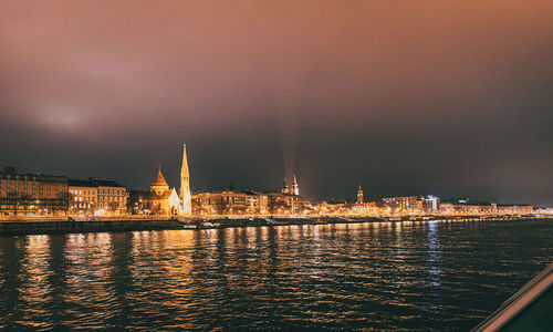 Illuminated city at sunset