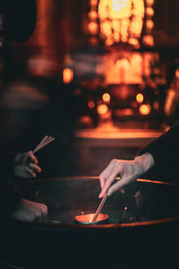 People lighting incense in a temple