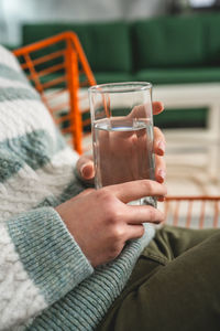 Cropped hand of woman holding drink