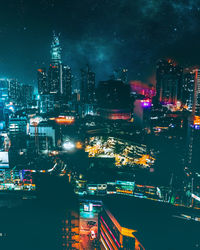 High angle view of illuminated buildings in city at night