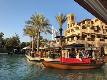 Boats in canal along buildings