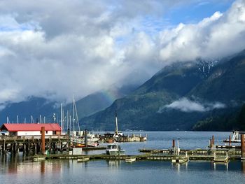 Sailboats moored in lake against sky