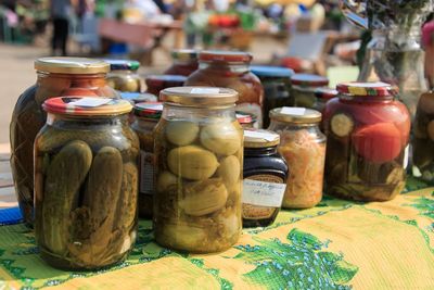 Close-up of jars on table at market stall