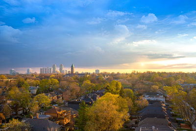 High angle view of trees and buildings during sunset