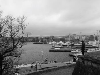 River in city against cloudy sky