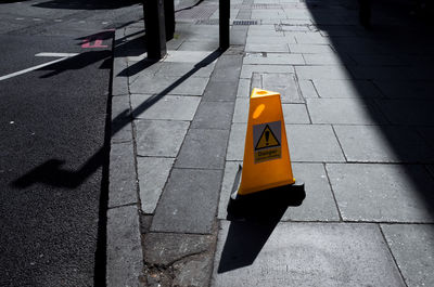 High angle view of yellow road sign on street