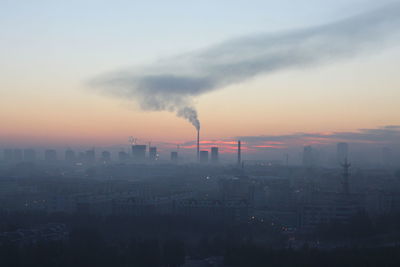 Smoke emitting from chimney against sky