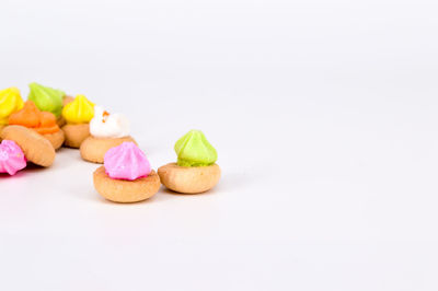 Close-up of multi colored cookies on white background