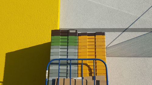 Multi colored shadow on yellow wall