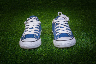 Close-up of shoes on grass