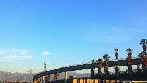 Low angle view of bridge against blue sky