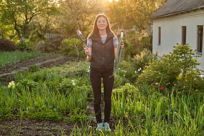 Woman works on the ground growing organic plants, fruits and vegetable