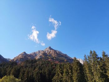 Scenic view of mountains against blue sky