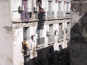 Graffiti on building wall with city in background