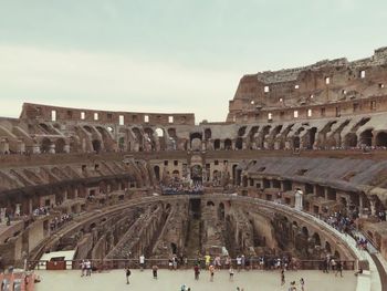 People in coliseum against sky