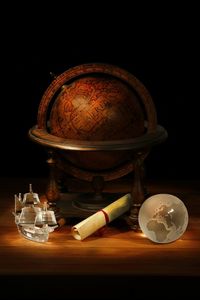 Close-up of lit candle in dark room