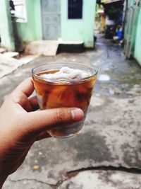 Midsection of person holding drink