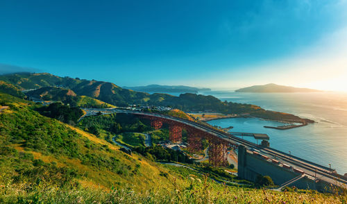 Scenic view of bridge over sea against blue sky