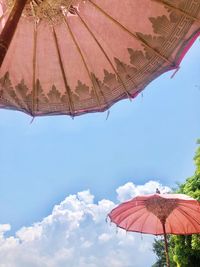 Low angle view of parasol against sky