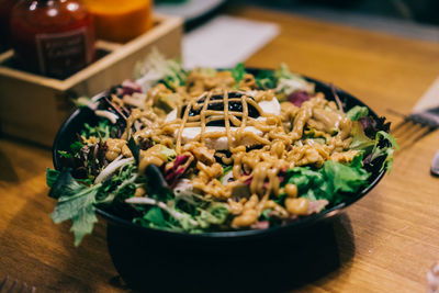 Close-up of salad in bowl on wooden table