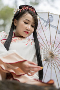 Young woman holding umbrella