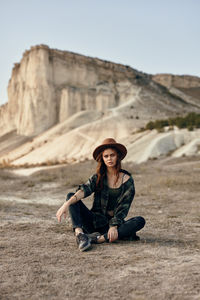 Young woman sitting on rock