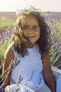 Beautiful girl in a field of lavender on sunset. family vacation concept