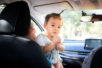 Portrait of boy with children in car