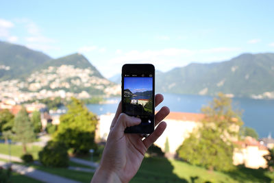 Close-up of cropped hand holding camera