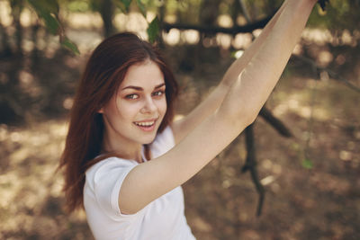 Portrait of a smiling young woman in forest