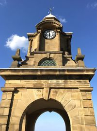 Low angle view of clock tower against sky