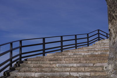 Low angle view of staircase against blue sky