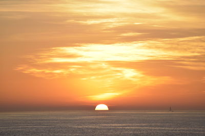 Scenic view of sea against orange sky