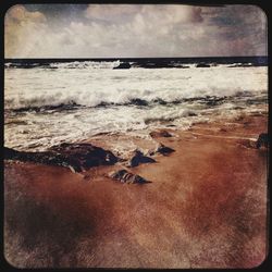 Scenic view of sea against cloudy sky