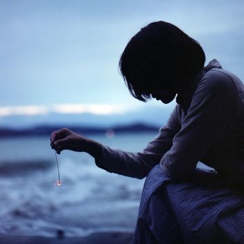 Close-up side view of woman holding sparklers