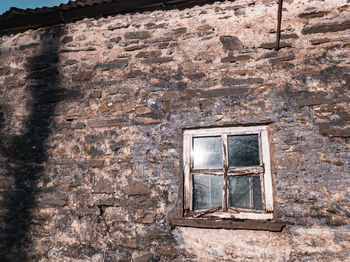 Low angle view of window on old building