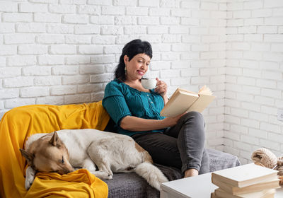 Portrait of woman with dog on book