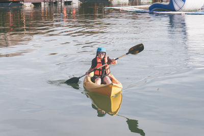 Woman kayaking in lake