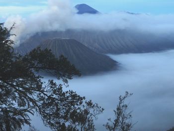 Scenic view of volcanoes in the clouds