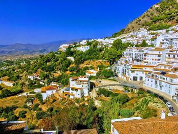 Buildings in town against blue sky